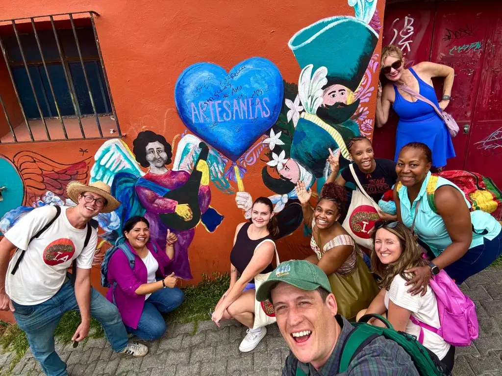 Iguana Abroad Spanish Immersion students posing in front of a street mural in Tepoztlan, Mexico