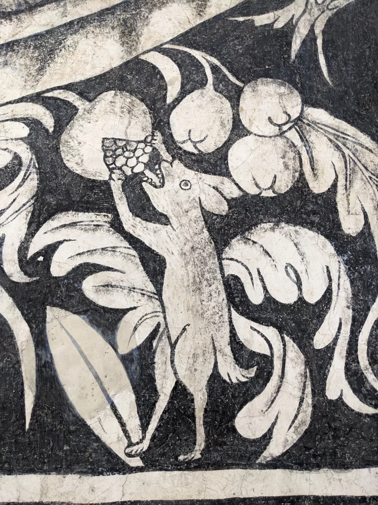 Close-up shot of a 16th Century fresco at the Divine Savior Parish and Augustinian Monastery in Malinalco, depicting an animal eating fruit