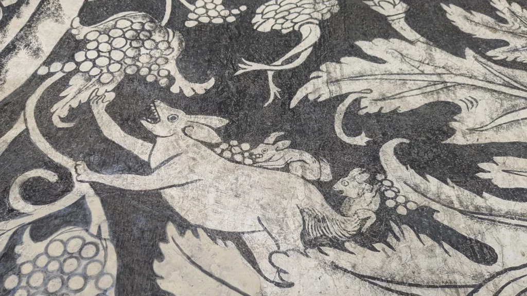 Close-up shot of an animal eating a fruit in a 16th-century fresco in the Divine Savior Augustinian Monastery (Convento del Divino Salvador) in Malinalco, Mexico