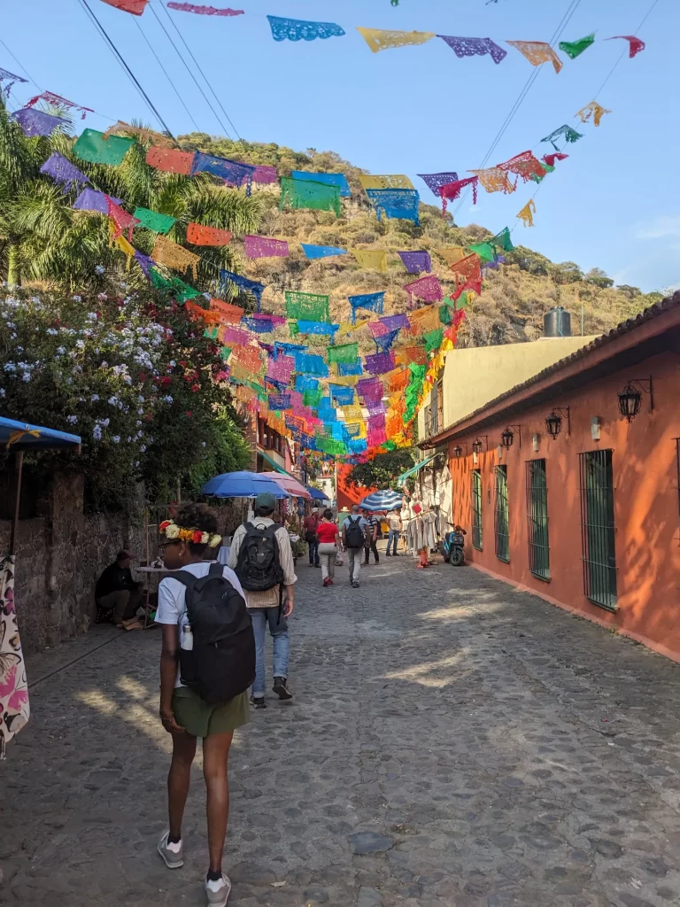 Colorful colonial house in Malinalco Mexico, in the evening, with decorative papel picada bunting hanging above