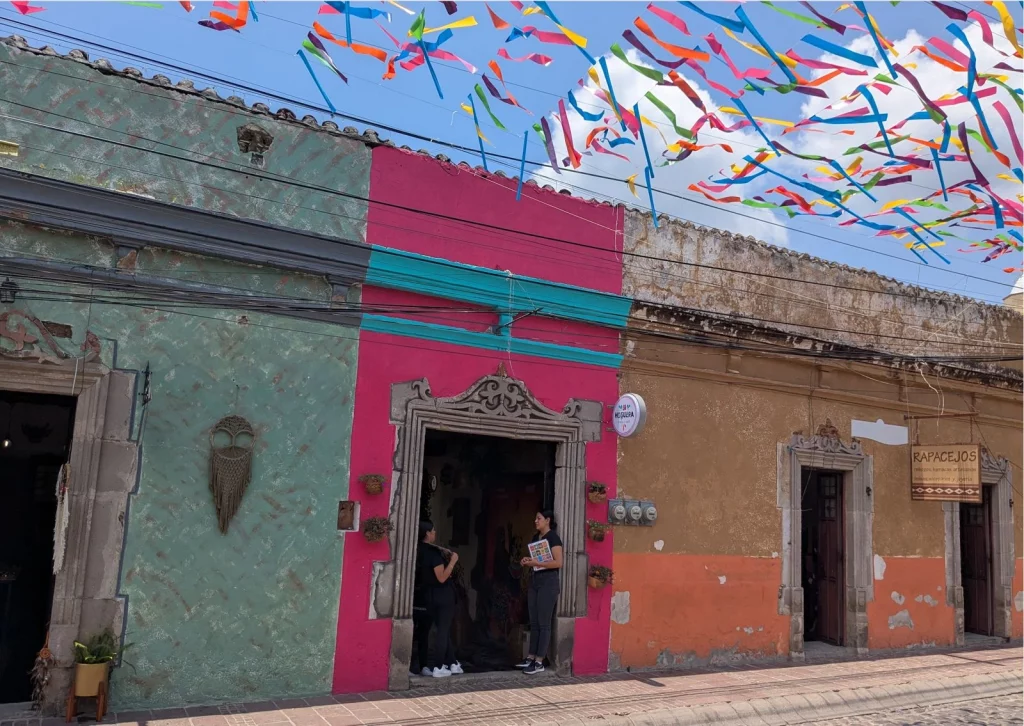 Colorful houses in Malinalco with colorful Papel Picado flags hung above