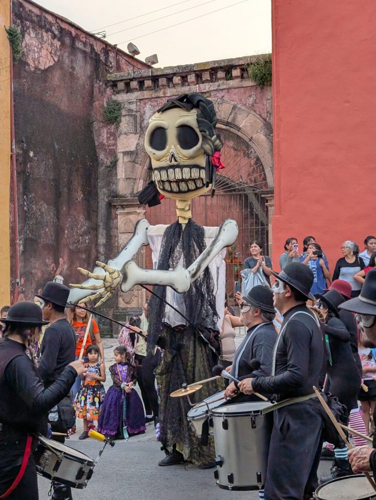 "Catrina" Mojiganga puppet, musicians, and children in the Day of the Dead parade in Cuernavaca, Mexico