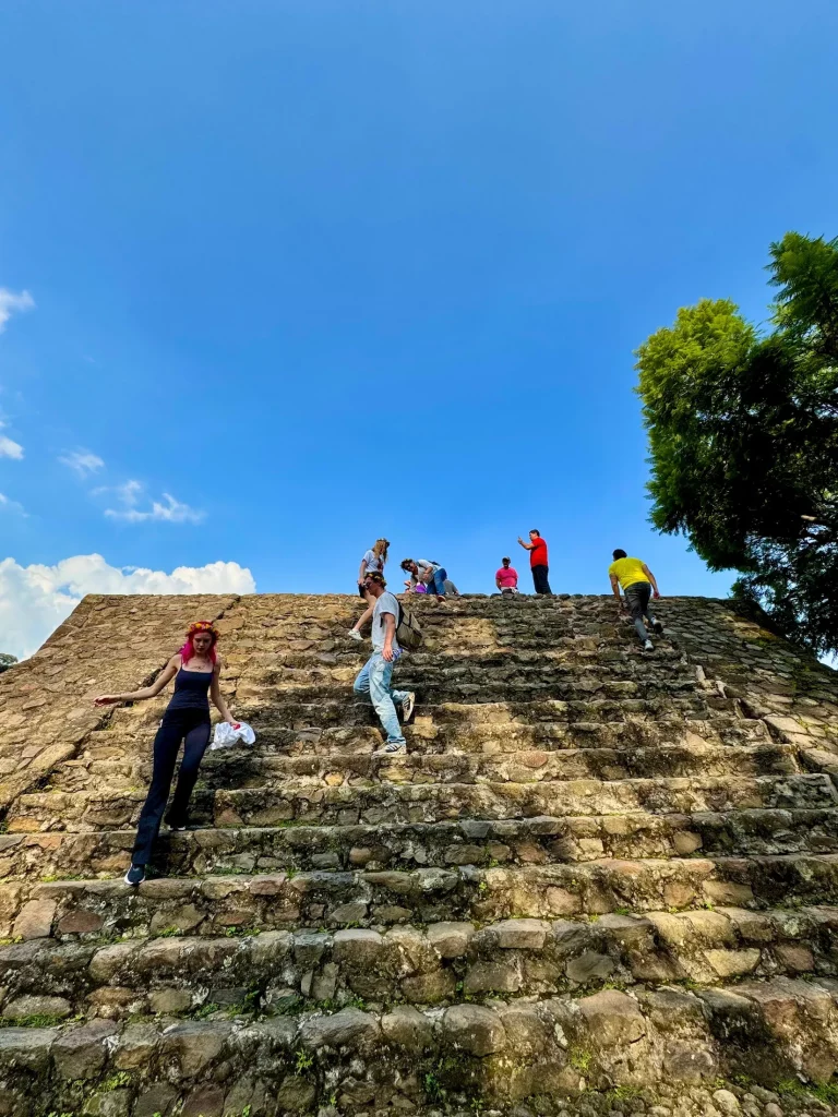 People descending the steps of the Cuauhcalli Pyramid in Malinalco Archeological Zone, Malinalco, Mexico