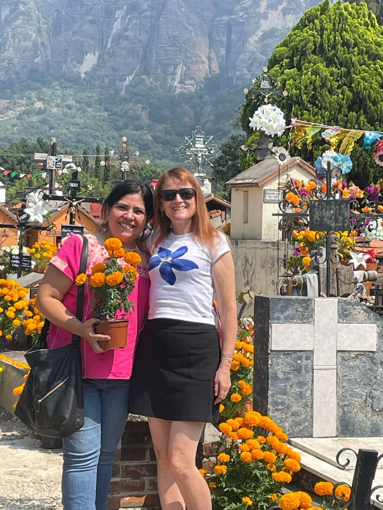Woman exploring a graveyard on day of the dead in Tepoztlan Mexico after retiring to Mexico