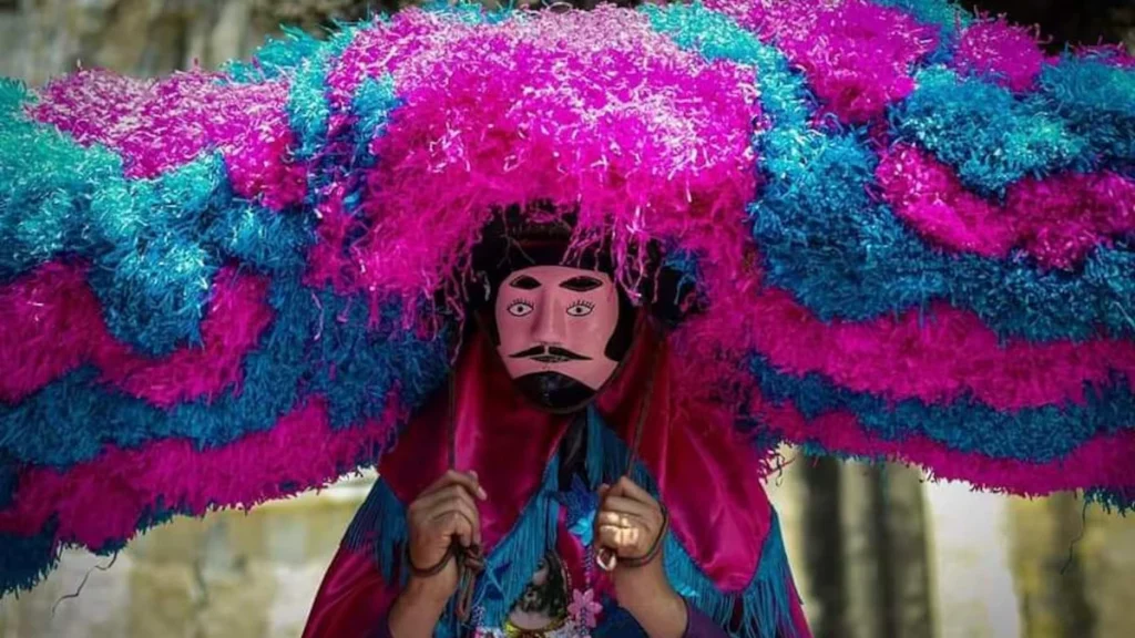 Costumed masked figure in a semana Santa procession in Tetela del Volcan, Mexico