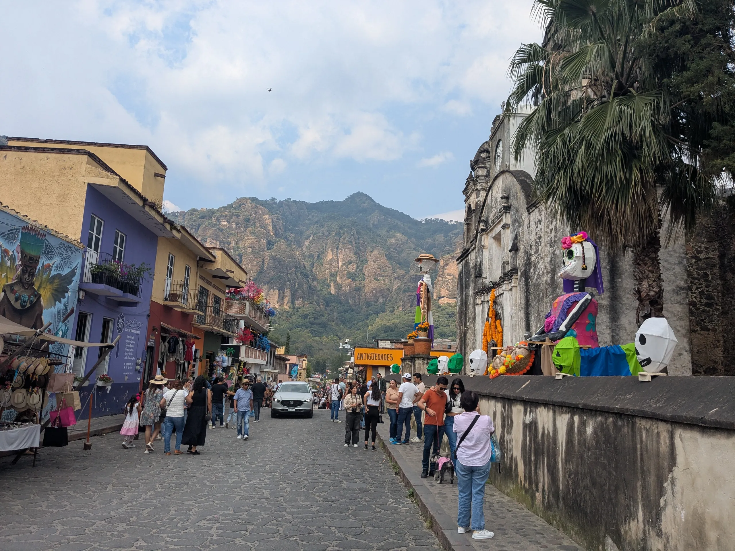 Main street in Tepoztlan looking towards the Tepozteco Pyramid with the Santo Domingo church in the foreground, on day of the dead