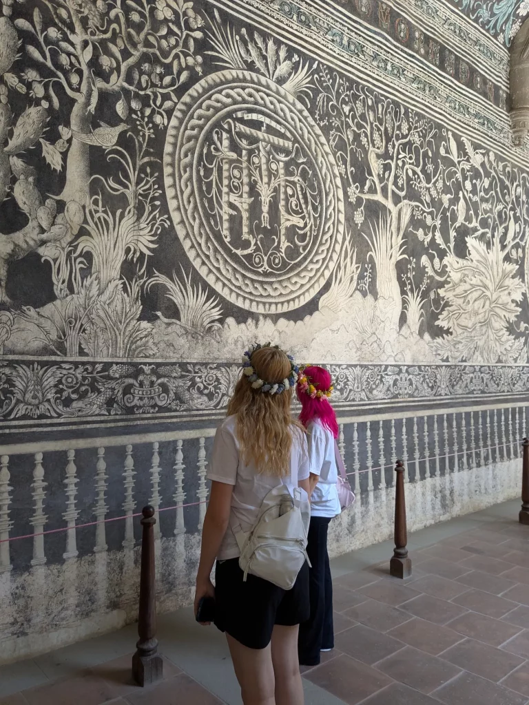Two female students looking at the 16th-century fresco in the Divine Savior Augustinian Monastery (Convento del Divino Salvador) in Malinalco, Mexico