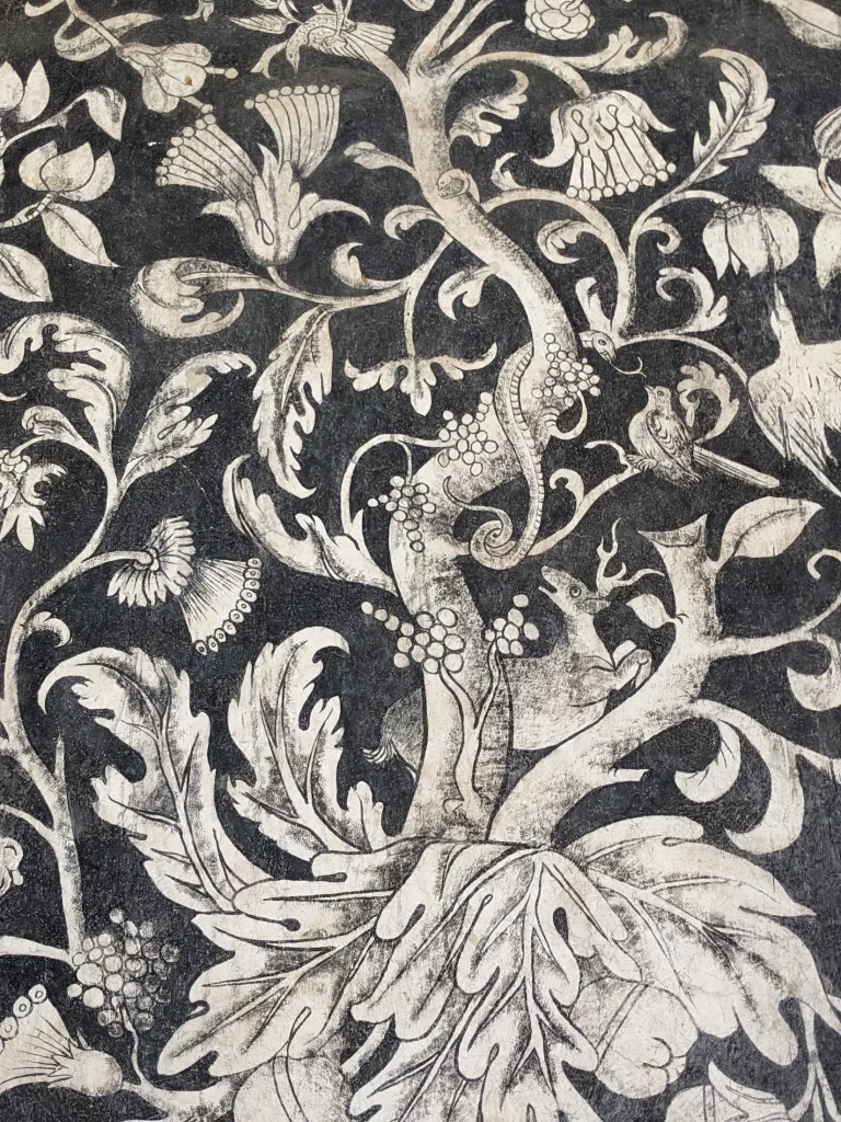 Vertical shot of an animal eating fruit in a 16th-century fresco in the Divine Savior Augustinian Monastery (Convento del Divino Salvador) in Malinalco, Mexico