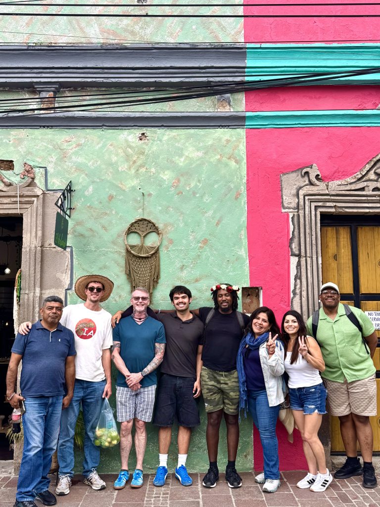 Spanish immersion students posing in front of colorful shop-fronts in Malinalco, Mexico