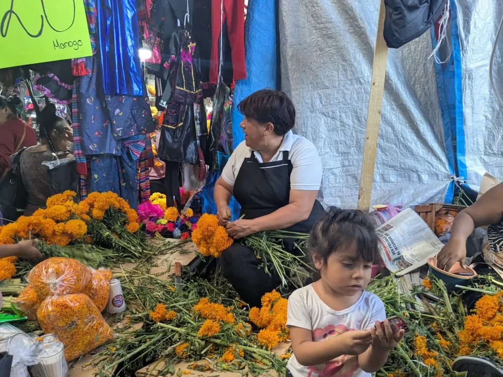 Woman selling Cempasuchil Marigold flowers in the Mercado Adolfo Lopez Mateos Market on Day of the Dead in Cuernavaca, Mexico