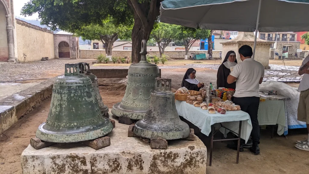 Nuns at the monastery in Tepoztlan, sat next to some large bells